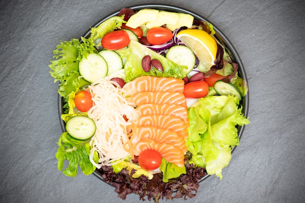 Delicious salmon salad in a menu with proper nutrition for weight loss